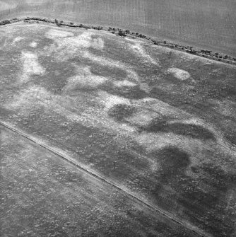 Nethermill School, oblique aerial view, taken from the SSW, centred on the cropmark of an enclosure.