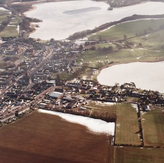 Lochmaben, oblique aerial view, taken from the NW, centred on the S part of the town, with St Mary Magdalene's church and burial ground and Lochmaben old castle and motte visible in the centre of the photograph.