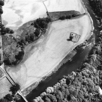 Oblique aerial view centred on burial ground from W.