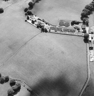 Oblique aerial view of Fairholm, taken from the NE, centred on the cropmarks of a fort.