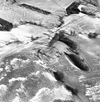 Broom Hill, oblique aerial view, taken from the WSW, centred on the remains of a fort and enclosure, with cultivation remains surrounding and an enclosure to the top of the photograph.