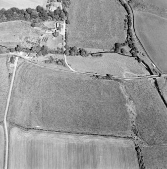 Oblique aerial view of Birrens, taken from the W, centred on a Roman Fort.  A watermill, situated to the E of the fort is visible in the top left-hand corner of the photograph.