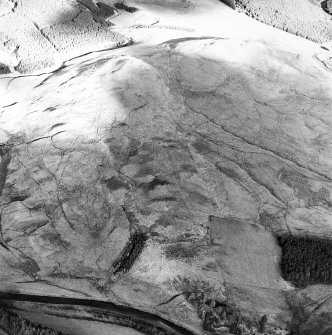 Raeburnfoot, oblique aerial view, taken from the SW, centred on the bank barrow. Enclosures at Kiln Syke are visible in the bottom right-hand corner of the photograph.