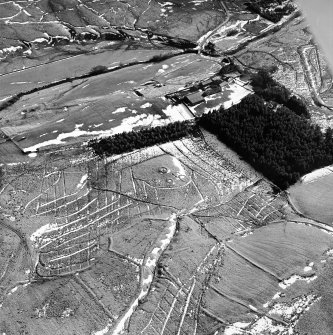 Calf Knowe, oblique aerial view, taken from the N, centred on ring-enclosures and huts.