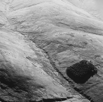 Oblique aerial view of Wrangway Burn centred on the remains of hollow-ways, a road, a possible Roman road and linear earthwork, taken from the NE.