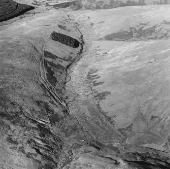 Oblique aerial view of Wrangway Burn centred on the remains of hollow-ways, a road, a possible Roman road, linear earthworks and a possible Roman watch tower, taken from the S.