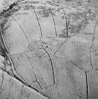 Oblique aerial view of Ettleton Sike centred on the remains of a farmstead, field-system, rig and boundary banks with further rig and boundary banks adjacent, taken from the WNW.