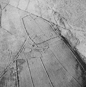 Oblique aerial view of Ettleton Sike centred on the remains of a farmstead, field-system, rig and boundary banks with further rig and boundary banks adjacent, taken from the ESE.