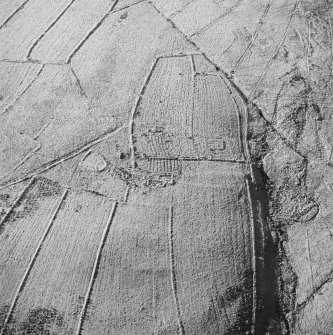 Oblique aerial view of Ettleton Sike centred on the remains of a farmstead, field-system, rig and boundary banks with further rig and boundary banks adjacent, taken from the ENE.