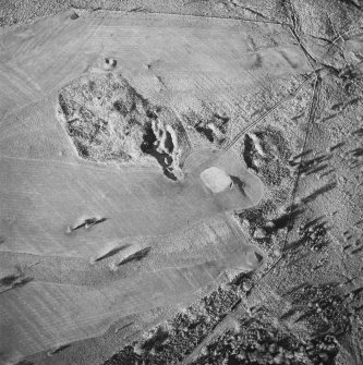 Oblique aerial view of Charlie's Sike centred on the remains of a settlement and quarries with boundary banks and rig adjacent, taken from the SE.