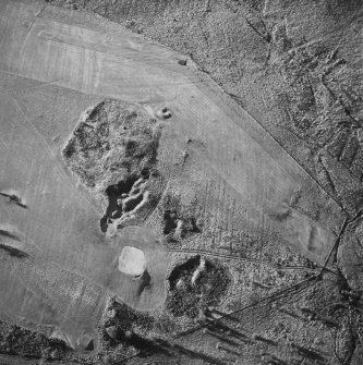 Oblique aerial view of Charlie's Sike centred on the remains of a settlement and quarries with boundary banks and rig adjacent, taken from the ENE.