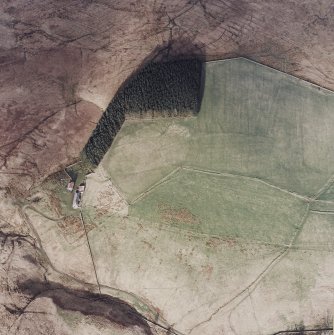 Oblique aerial view centred on the remains of the field-system, lazy-beds and cottage, taken from the WSW.