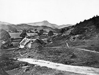 Copy of historic photograph in the Annan Album showing an unidentified view of thatch cottages in Aberfoyle.