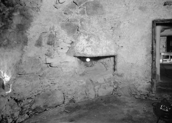 Interior view of Castle Fraser showing view of shot-hole at base of SE tower.