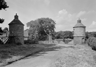 View of gate piers and twi dovecots with East Lodge in background, Balcaskie House.