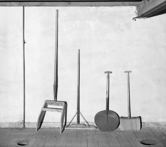 Aberdeen, Berryden Road, Millbank Mill, Corn Mill, Interior.
Detail of various implements used in grain drying kiln.
Pushing Implements. (left to right)
1st Two. for clearing grain off floor into discharge spouts.
3rd. possibly a cove shovel for kiln fuel.
4th. shovel for turning grain on drying floor.