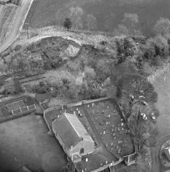 Oblique aerial view of Barton Hill motte under excavation and Kinnaird Parish Church and churchyard.
