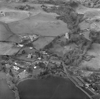 Oblique aerial view of Kinnaird Castle and village and Barton Hill motte under excavation.