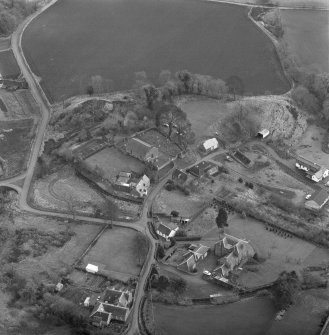 Oblique aerial view of Barton Hill motte under excavation and Kinnaird village.
