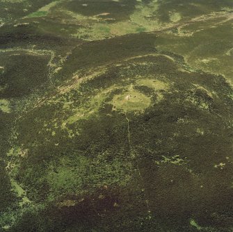 Oblique aerial view of the remains of a cairn at King's Seat.

