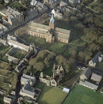 Oblique aerial view of St Magnus Cathedral, Earl's Palace and Bishop's Palace, Kirkwall.