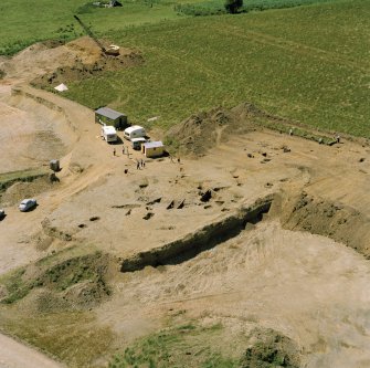 Oblique aerial view showing the excavation at the site at Dalladies.