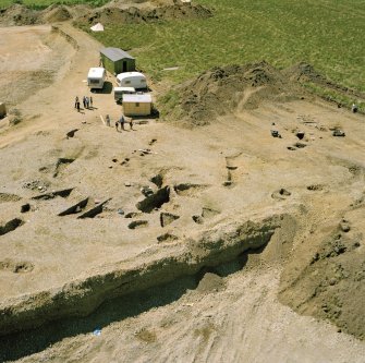 Oblique aerial view showing the excavation at the site at Dalladies.