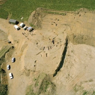 Oblique aerial view showing the excavation at the site at Dalladies.