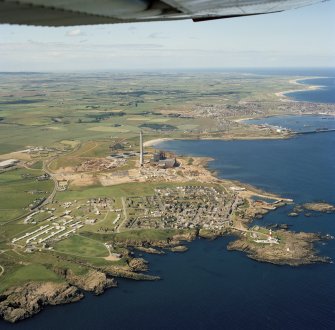 Oblique aerial view of Peterhead Power Station under construction, Boddam village and Buchan Ness lighthouse.