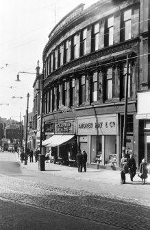 Glasgow, Cowcaddens Cross.
Detail of Cowcaddens Street.
Shops seen are; Andrew Hay and Co. (no.112), Caledonian Taylors (no.114), Dinah Lovitt (no.118).
