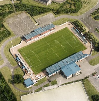 Oblique aerial view centred on the football ground, taken from the WNW.