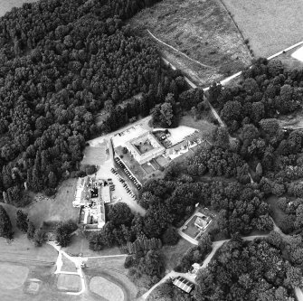 Oblique aerial view centred on the stable with club house and country house adjacent, taken from the SSE.