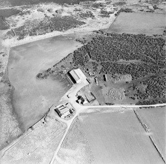Oblique aerial view centred on the farmsteads, taken from the NE.