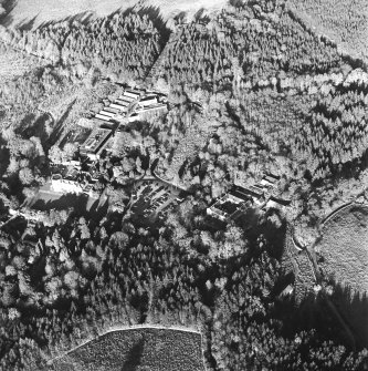 Oblique aerial view centred on the farmstead, the country house and hotel, taken from the W.