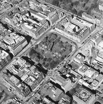 Oblique aerial view centred on St Andrew Square with the construction of the shop and bus station and the bank adjacent, taken from the SE.