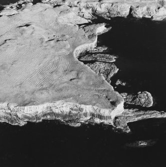 Oblique aerial view of Staffa, taken from the north west, centred on building remains.