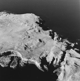 Oblique aerial view of Staffa, taken from the south west, centred on building remains.