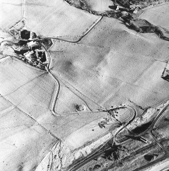 Auchengallon, oblique aerial view, taken from the W, centred on a cairn. A township is visible in the centre left of the photograph.