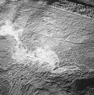 Tormore, oblique aerial view, taken from the SW, centred on a hut-circle. A further hut-circle is visible in the centre left of the photograph.