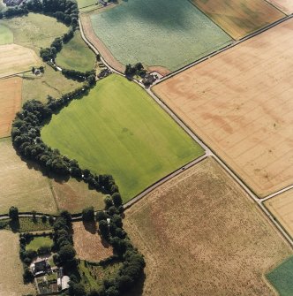 Oblique aerial view centred on the cropmarks of the SE entrance of the Roman temporary camp and the settlement, with the manse adjacent, taken from the ENE.