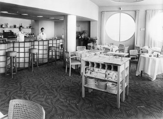 Interior view of the NEB / Atlantic Restaurant at the Empire Exhibition, showing the circular windows at the end, the glass block of the curved bar and tables, chairs, etc.