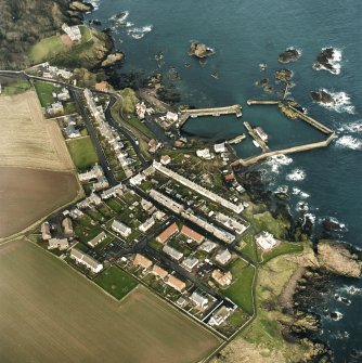 Oblique aerial view centred on the village and harbour, taken from the S.