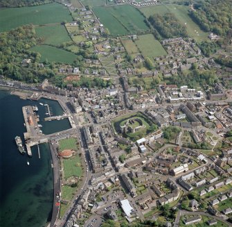 General oblique aerial view of Rothesay centred on the remains of the castle and chapel, with the winter gardens and pier adjacent taken from the W - image supersedes SC1683051