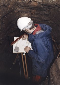 Commission at work: Mr I Parker carrying out plane table survey in the cistern (lower chamber).