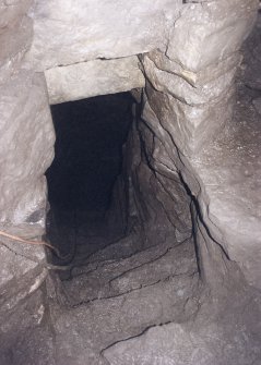 View along the half landing down the lower flight of steps to the lower chamber (cistern).  The smaller side gallery is on the right.
