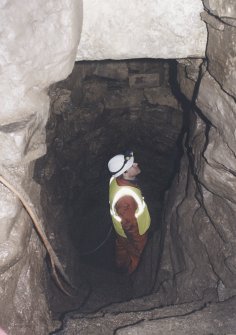 Mr R Shaw in the lower chamber (cistern), seen from the lower flight of steps leading down from the half-landing.
