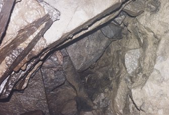 View into void above the upper flight of steps showing junction of natural and drystone walling.