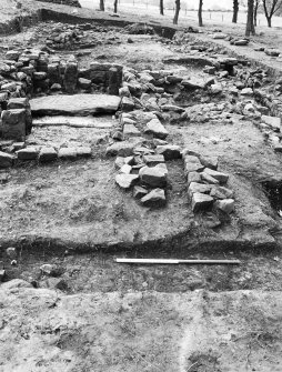 Excavation photograph : Bathhouse, from east, showing Room 4 in foreground, with stone lined hypocaust pillars and flooring slab on basement floor.