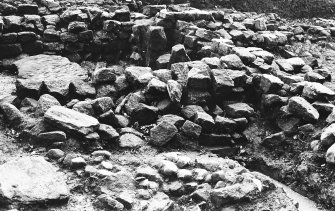 Excavation photograph : Room 5 from north with hypocaust pillars and flooring slab on basement floor.