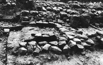 Excavation photograph : Room 4 and stone lined flue, with Room 5 to right - from north.